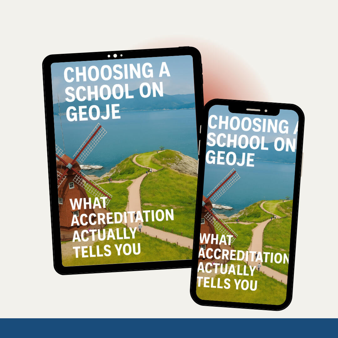 Mockup of an ebook cover displayed on a tablet and smartphone, titled “Choosing a School on Geoje: What Accreditation Actually Tells You,” featuring a windmill overlooking Geoje’s coastal landscape.